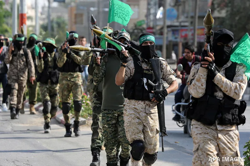 Palestinian members of al-Qassam Brigades, the armed wing of the Hamas movement, display their weapons during a military parade, in Khan Yunis City, southern Gaza strip, on November 11, 2019. Photo by Ashraf Amra