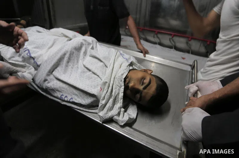 Relatives of Palestinians, who were died hit by an Israeli airstrike react at el-Shifa hospital morgue, in Gaza city on November 13, 2019. Photo by Ashraf Amra