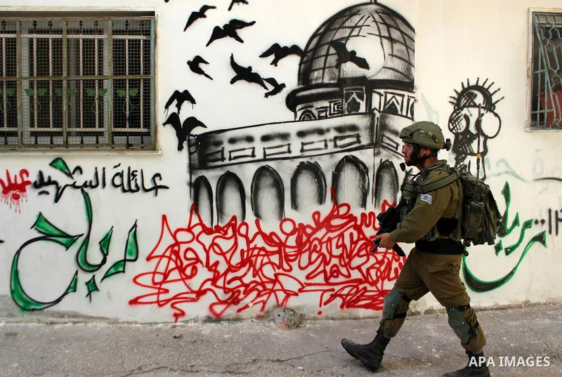 Israeli security forces take position during clashes with Palestinian protesters following at al-Arrub refugee camp, north of Hebron in the southern West Bank on November 13, 2019. Photo by Mosab Shawer