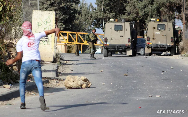 Palestinian protesters hurl stones towards Israeli security forces at al-Arrub refugee camp, north of Hebron in the southern West Bank on November 13, 2019. Photo by Mosab Shawer