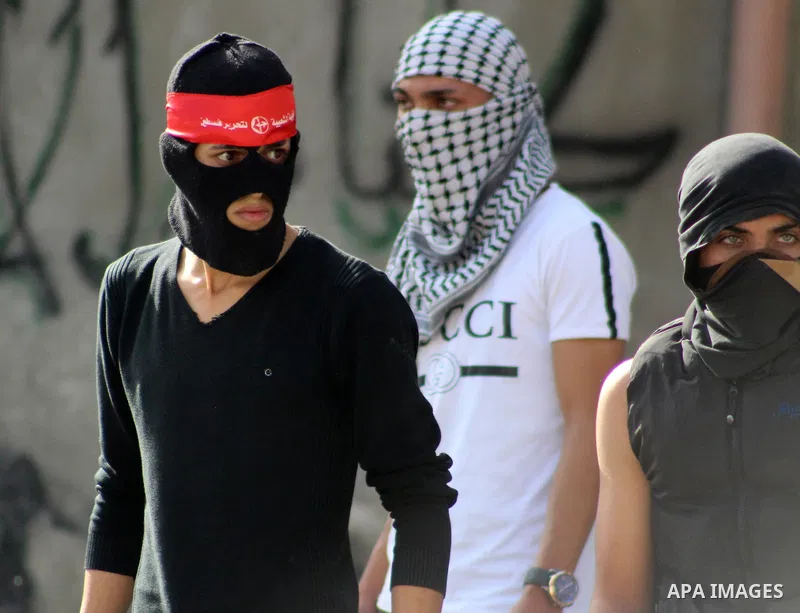 Palestinian protesters hurl stones towards Israeli security forces at al-Arrub refugee camp, north of Hebron in the southern West Bank on November 13, 2019. Photo by Mosab Shawer