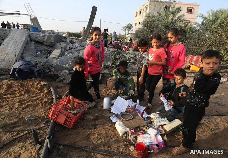 Palestinians inspect the damaged house destroyed in an Israeli air strike in Khan Yunis in the southern Gaza Strip November 13, 2019. Photo by Abed Deeb