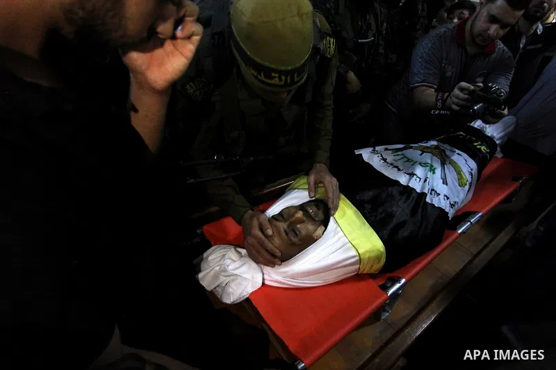 Relatives of Palestinian Yousef Abu Kamil, who was died hit by an Israeli airstrike, mourn over his body during his funeral in Gaza city on November 14, 2019. Photo by Mahmoud Ajjour