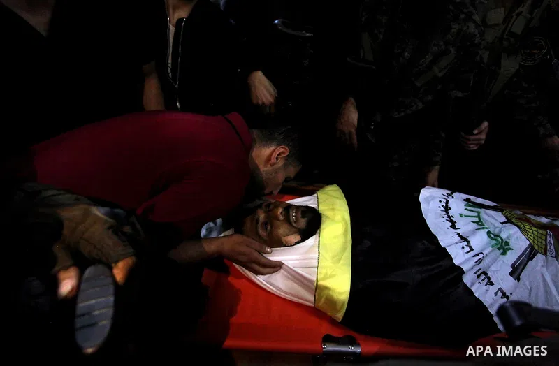 Relatives of Palestinian Yousef Abu Kamil, who was died hit by an Israeli airstrike, mourn over his body during his funeral in Gaza city on November 14, 2019. Photo by Mahmoud Ajjour