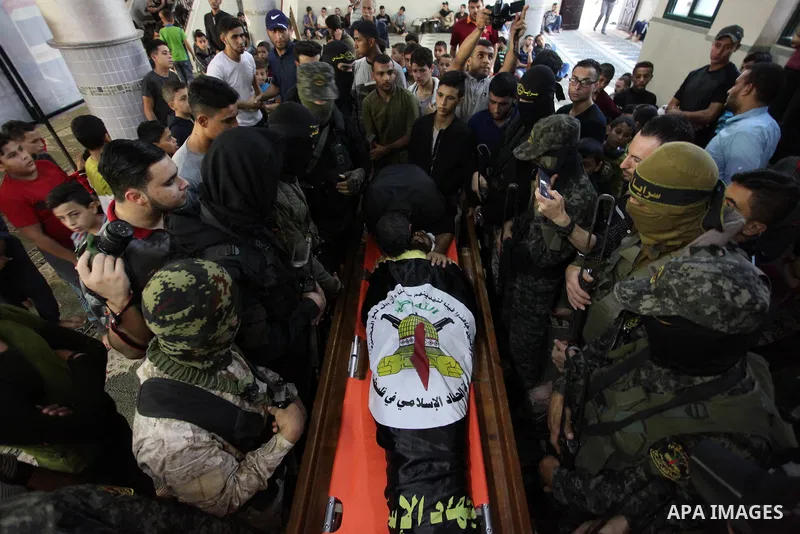 Relatives of Palestinian Yousef Abu Kamil, who was died hit by an Israeli airstrike, mourn over his body during his funeral in Gaza city on November 14, 2019. Photo by Mahmoud Ajjour