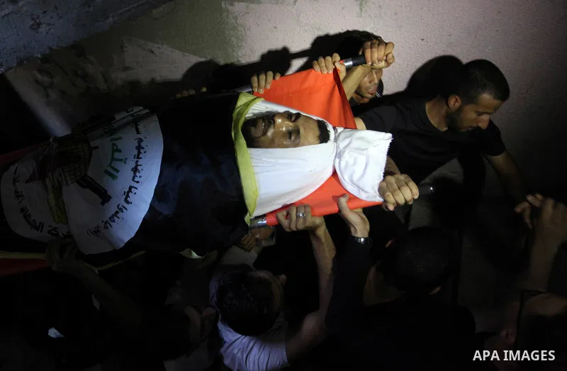 Mourners carry the body of Palestinian Yousef Abu Kamil, who was died hit by an Israeli airstrike during his funeral in Gaza city on November 14, 2019. Photo by Mahmoud Ajjour