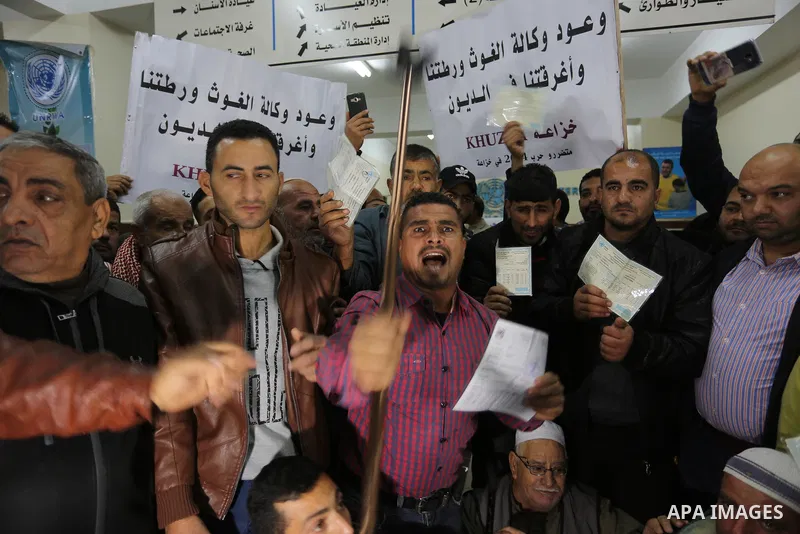 Palestinian owners of houses which were destroyed during the recent Israeli war, take part in a protest demanding repair their houses, at a United Nations-run health center, in Khan Younis in the southern of Gaza strip,...