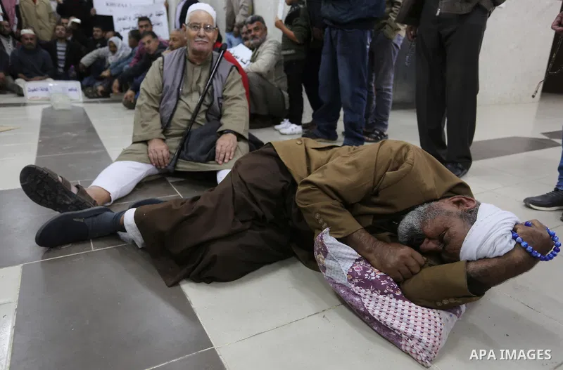 Palestinian owners of houses which were destroyed during the recent Israeli war, take part in a protest demanding repair their houses, at a United Nations-run health center, in Khan Younis in the southern of Gaza strip,...