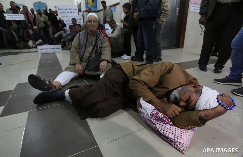 Palestinian owners of houses which were destroyed during the recent Israeli war, take part in a protest demanding repair their houses, at a United Nations-run health center, in Khan Younis in the southern of Gaza strip,...