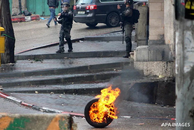 Israeli security forces take position during clashes with Palestinian protesters following protest over a U.S. decision on Jewish settlements, in the West Bank city of Hebron on December 9, 2019. Photo by Mosab Shawer
