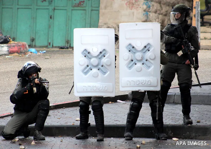 Israeli security forces take position during clashes with Palestinian protesters following protest over a U.S. decision on Jewish settlements, in the West Bank city of Hebron on December 9, 2019. Photo by Mosab Shawer