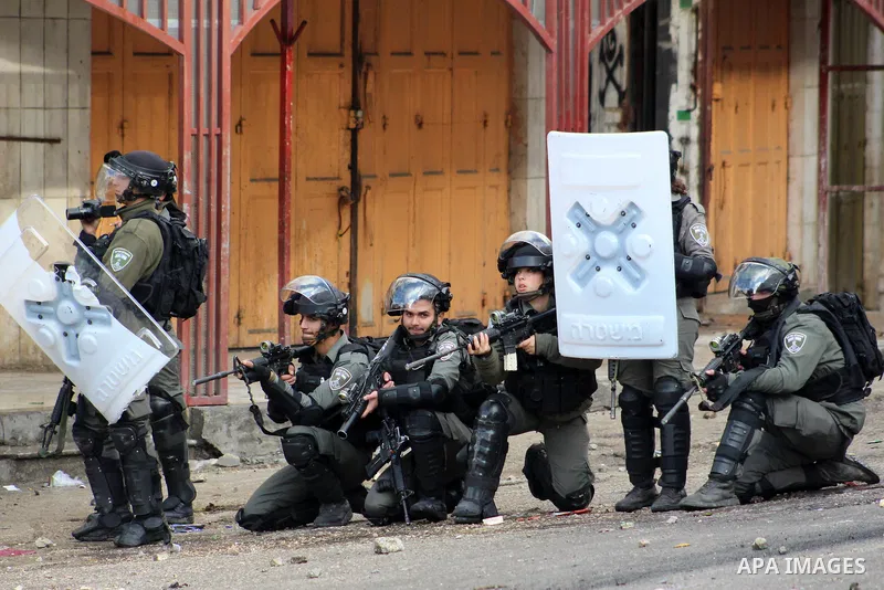 Israeli security forces take position during clashes with Palestinian protesters following protest over a U.S. decision on Jewish settlements, in the West Bank city of Hebron on December 9, 2019. Photo by Mosab Shawer