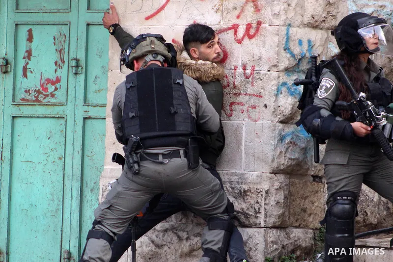 Israeli security forces arrest Palestinian youth during a protest over a U.S. decision on Jewish settlements, in the West Bank city of Hebron on December 9, 2019. Photo by Mosab Shawer