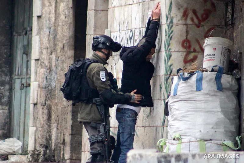 Israeli security forces arrest Palestinian youth during a protest over a U.S. decision on Jewish settlements, in the West Bank city of Hebron on December 9, 2019. Photo by Mosab Shawer