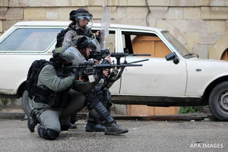 Israeli security forces take position during clashes with Palestinian protesters following protest over a U.S. decision on Jewish settlements, in the West Bank city of Hebron on December 9, 2019. Photo by Mosab Shawer