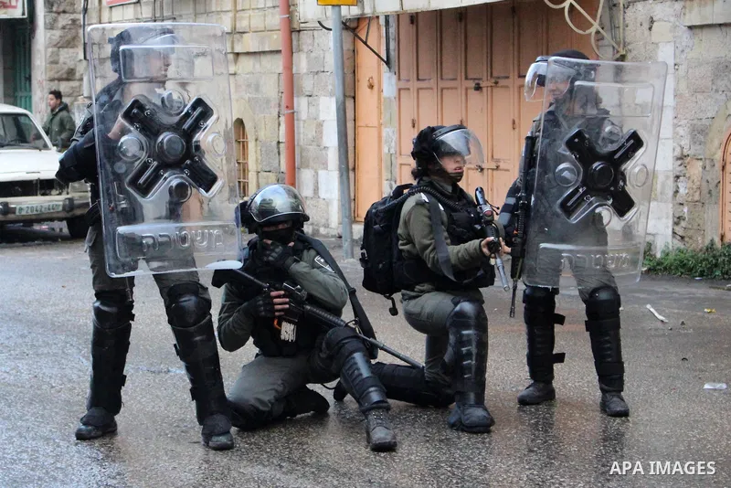 Israeli security forces take position during clashes with Palestinian protesters following protest over a U.S. decision on Jewish settlements, in the West Bank city of Hebron on December 9, 2019. Photo by Mosab Shawer