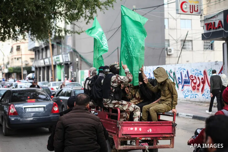 Members of Hamas' armed wing al-Qassam Brigades walk in a street, marking the 32th anniversary of the founding of the Hamas movement, in Gaza city on December 11, 2019. Photo by Mahmoud Ajjour
