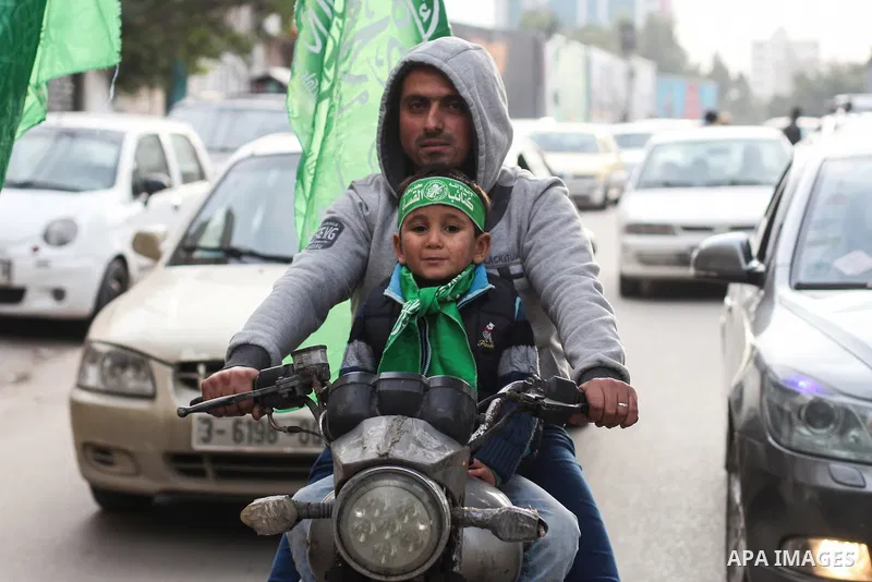 A Palestinian walks in a street, Marking the 32th anniversary of the founding of the Hamas movement, in Gaza city on December 11, 2019. Photo by Mahmoud Ajjour