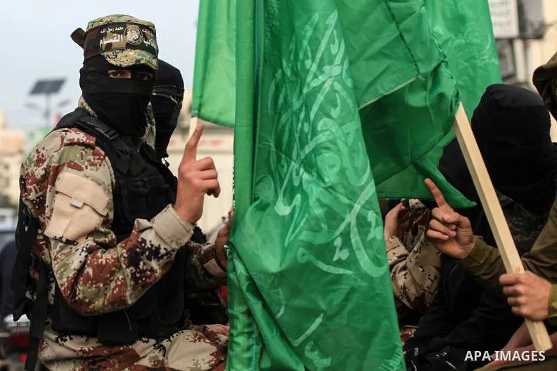 Members of Hamas' armed wing al-Qassam Brigades walk in a street, marking the 32th anniversary of the founding of the Hamas movement, in Gaza city on December 11, 2019. Photo by Mahmoud Ajjour