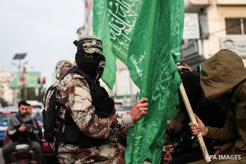 Members of Hamas' armed wing al-Qassam Brigades walk in a street, marking the 32th anniversary of the founding of the Hamas movement, in Gaza city on December 11, 2019. Photo by Mahmoud Ajjour