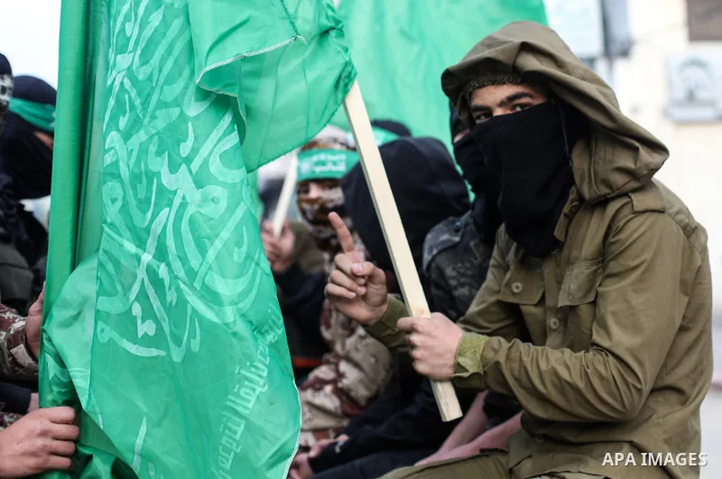 Members of Hamas' armed wing al-Qassam Brigades walk in a street, marking the 32th anniversary of the founding of the Hamas movement, in Gaza city on December 11, 2019. Photo by Mahmoud Ajjour
