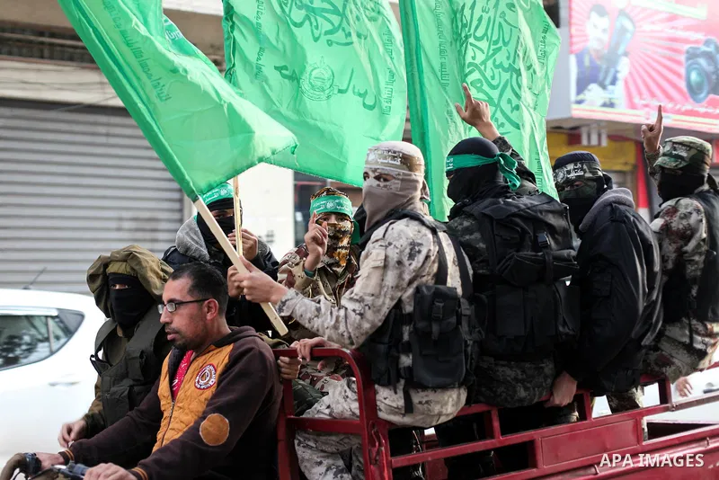 Members of Hamas' armed wing al-Qassam Brigades walk in a street, marking the 32th anniversary of the founding of the Hamas movement, in Gaza city on December 11, 2019. Photo by Mahmoud Ajjour