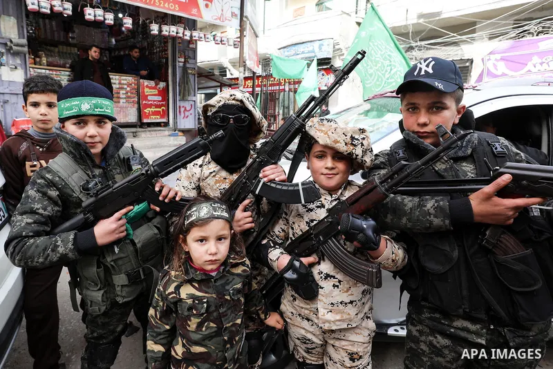 Palestinian children takes part in a marking the 32th anniversary of the Islamist movement's founding In Jabalia, northern Gaza Strip, on December 13, 2019. Photo by Mahmoud Nasser