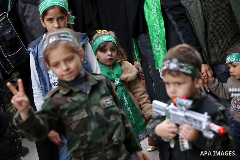 Palestinian child takes part in a marking the 32th anniversary of the Islamic movement's founding in Khan Younis in the southern of Gaza strip, on December 13, 2019. Photo by Ashraf Amra