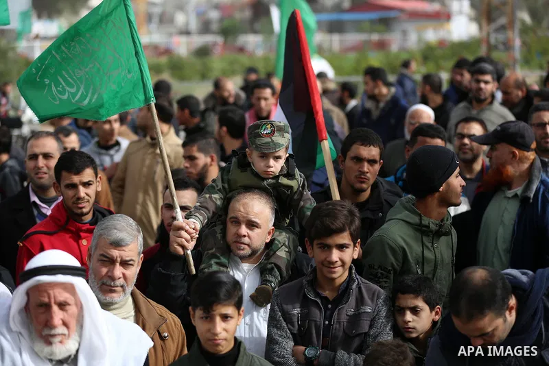 Palestinian Hamas supporters gather to attend a Hamas rally marking the 32th anniversary of the Islamist movement's founding in Khan Younis in the southern of Gaza strip, on December 13, 2019. Photo by Ashraf Amra