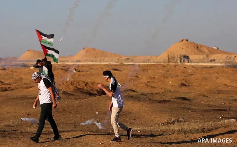 Palestinian protesters clash with Israeli troops following the tents protest where Palestinians demand the right to return to their homeland at the Israel-Gaza border, in Khan Younis in the southern Gaza Strip, on Decemb...