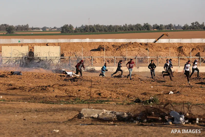 Palestinian protesters clash with Israeli troops following the tents protest where Palestinians demand the right to return to their homeland at the Israel-Gaza border, in Khan Younis in the southern Gaza Strip, on Decemb...