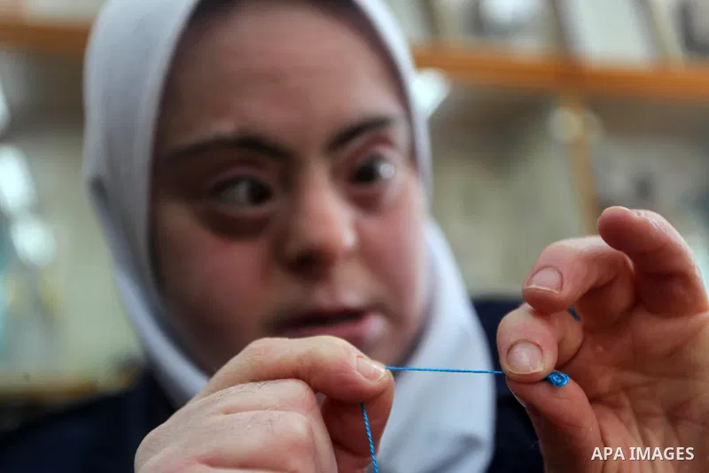 Palestinian women with Down syndrome work on embroidery at association "Right of life" in Gaza city, on December 22, 2019. In the blockaded Gaza Strip with a population of 2 million, there are about 1,800 people with Dow...