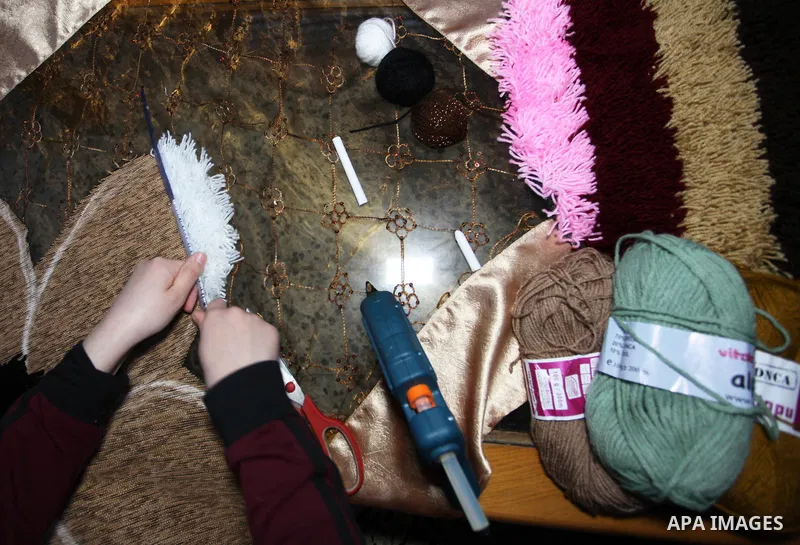 Palestinian student, Maram al-Haj Ahmed, 21, weaves carpets at her home, in Gaza city, on December 23, 2019. Al-Haj Ahmed a dental surgery student, where she works in this profession to help herself to complete her study...