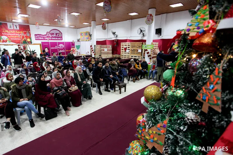 Palestinians make Christmas tree decorations from remnants of the environment, in Gaza city on December 26, 2019. Photo by Mahmoud Ajjour