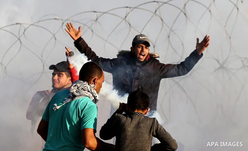 Palestinian protesters clash with Israeli troops following the tents protest where Palestinians demand the right to return to their homeland at the Israel-Gaza border, in Khan Younis in the southern Gaza Strip, on Decemb...