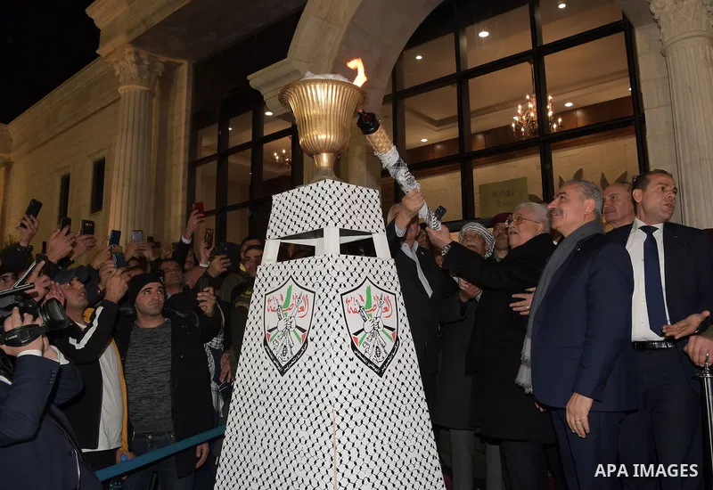 Palestinian President Mahmoud Abbas, light a torch during a ceremony marking the 55th anniversary of Fatah's founding, in the West Bank city of Ramallah, on December 31, 2019. Photo by Thaer Ganaim