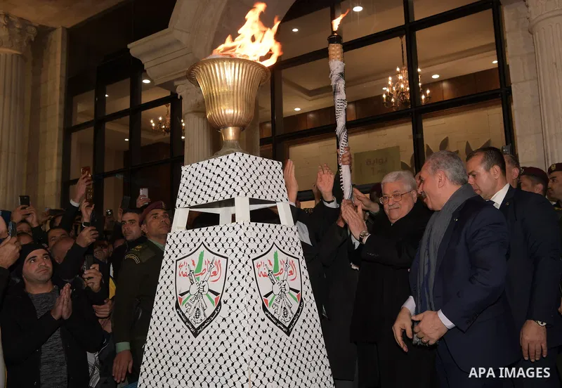 Palestinian President Mahmoud Abbas, light a torch during a ceremony marking the 55th anniversary of Fatah's founding, in the West Bank city of Ramallah, on December 31, 2019. Photo by Thaer Ganaim