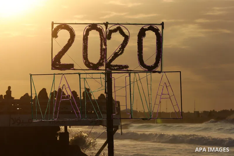 Palestinians enjoy their time on the beach during sunset in the last day of 2019, a few hours prior to the new year's celebrations, in Gaza city on December 31, 2019. Photo by Ashraf Amra