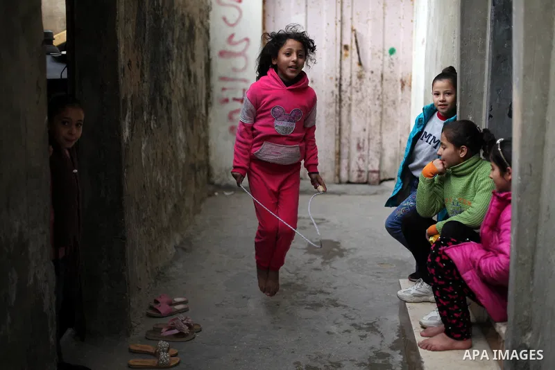 Palestinian refugees play outside their family house in al-Shati refugee camp, west Gaza city, on January 8, 2020. In 2018, President Trump cut aid to UNRWA and other Palestinian aid programs, threatening to topple the w...