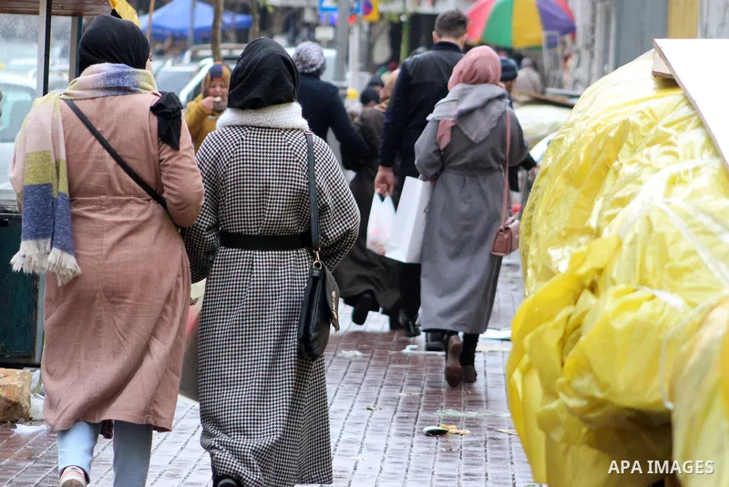 Palestinians walk in a street during a rainy day, in the West Bank city of Hebron, January 08, 2020. Photo by Mosab Shawer