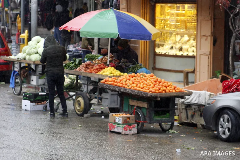 Palestinians walk in a street during a rainy day, in the West Bank city of Hebron, January 08, 2020. Photo by Mosab Shawer