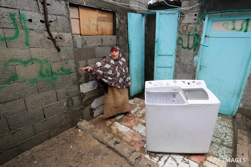 A Palestinian woman stands during a cold weather spell in an empoverished neighbourhood on the outskirts in Gaza City on January 9, 2020. Photo by Ashraf Amra