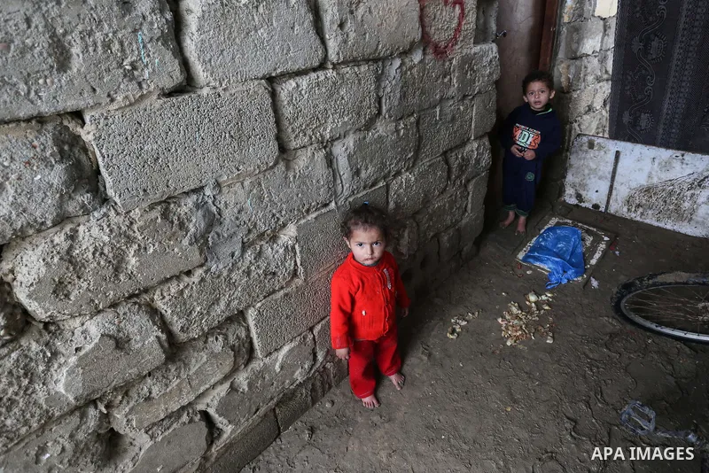 Palestinian children enjoy during a cold weather spell in an empoverished neighbourhood on the outskirts in Gaza City on January 9, 2020. Photo by Ashraf Amra