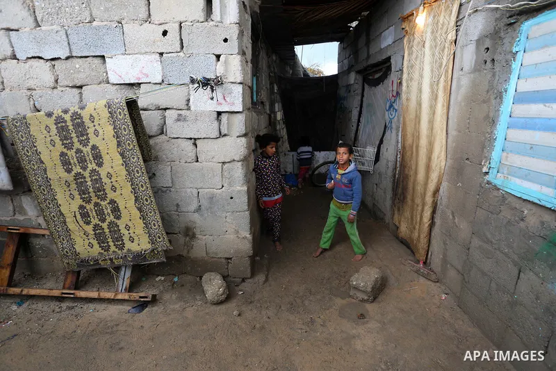Palestinian children enjoy during a cold weather spell in an empoverished neighbourhood on the outskirts in Gaza City on January 9, 2020. Photo by Ashraf Amra