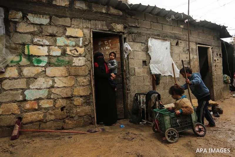 Palestinian children enjoy during a cold weather spell in an empoverished neighbourhood on the outskirts in Gaza City on January 9, 2020. Photo by Ashraf Amra