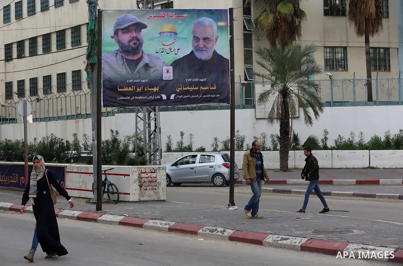 Palestinians walk past a mural depicting late Palestinian Islamic Jihad leader Baha Abu Al-Ata, the general Qasim Soleimani, in Gaza city on January 12, 2020. Photo by Ashraf Amra
