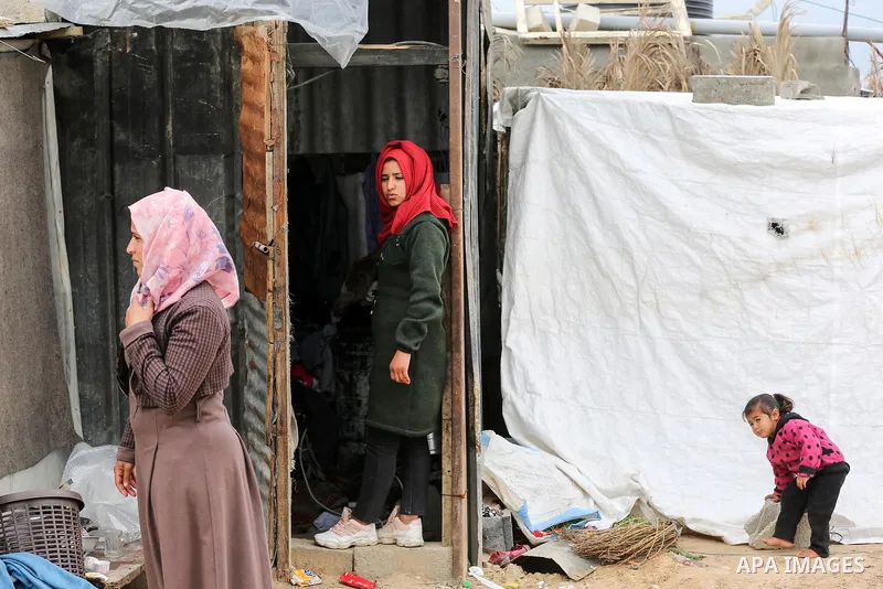 Palestinian family sits next to her destroyed house, on a winter cold day, in Khan Youns southern in Gaza city January 20, 2020. Photo by Ashraf Amra