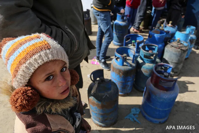 Palestinians wait near of the empty gas canisters at a natural gas station in Rafah in the southern Gaza Strip on January 21, 2020. The Gaza Strip is facing a gas crisis over the past few days due to the continued blocka...