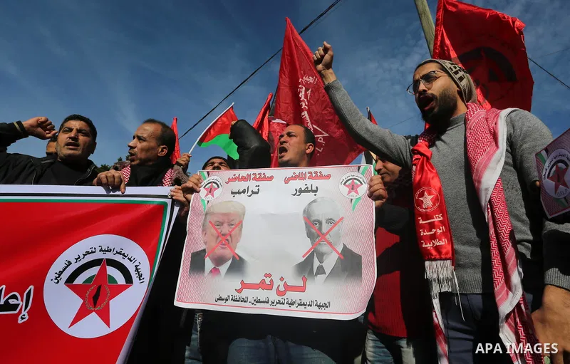 Palestinians supporters of the Democratic Front for the Liberation of Palestine (DFLP) holds banners depicting U.S. President Donald Trump during a protest against the U.S. Middle East peace plan, in front of the headqua...