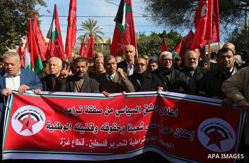 Palestinians supporters of the Democratic Front for the Liberation of Palestine (DFLP) holds banners depicting U.S. President Donald Trump during a protest against the U.S. Middle East peace plan, in front of the headqua...